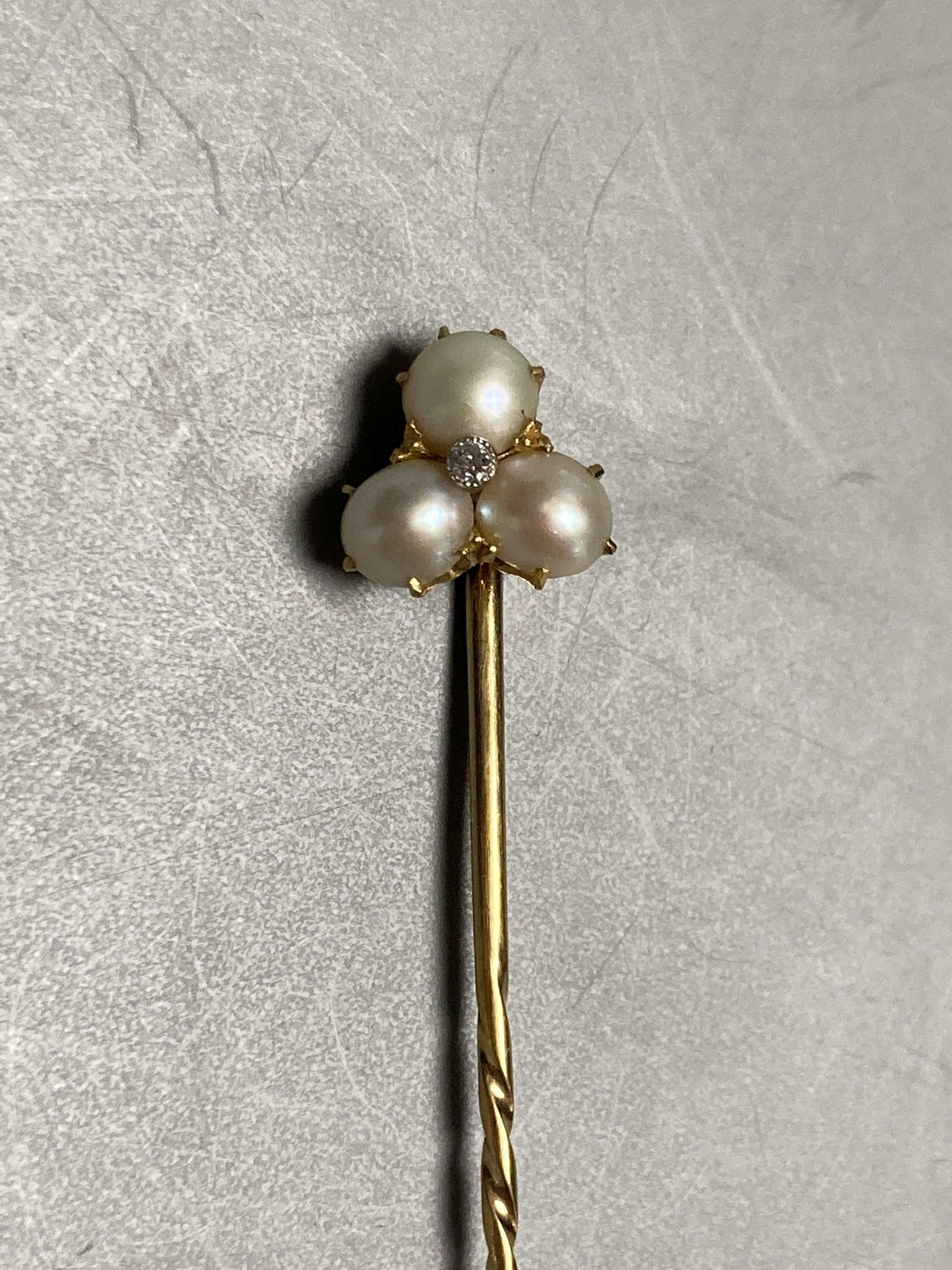 Four assorted late Victorian yellow metal stick pins and two tie pins.